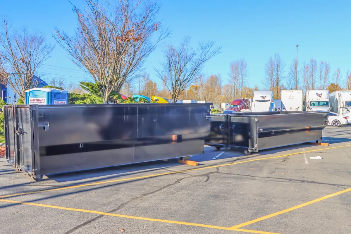 Professional dumpster rental service with roll-off container on residential driveway in Oceanport